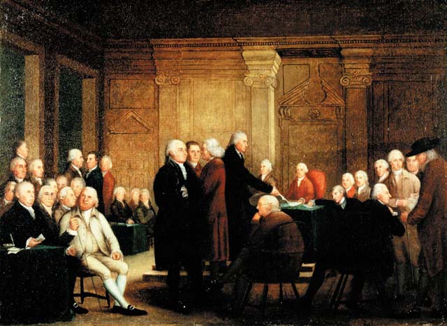 Painting of 25 - 30 men dressed in long coats and wigs in a room. Four men stand in the center of the image. The tallest of them is handing a piece of paper to a man seated near a table reaching to take the paper.